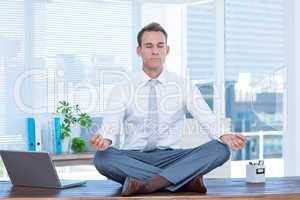 Zen businessman doing yoga meditation