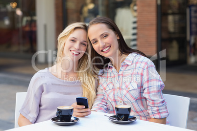 Happy women friends smiling at camera