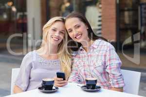 Happy women friends smiling at camera