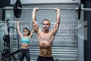 Muscular couple lifting weight together