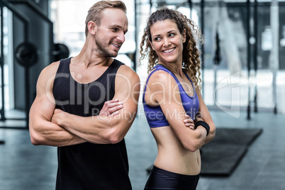 Muscular couple looking at each other