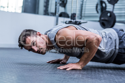 A muscular man doing a pushups