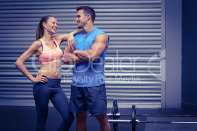 Smiling muscular couple discussing together