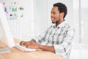 Young businessman typing on the laptop