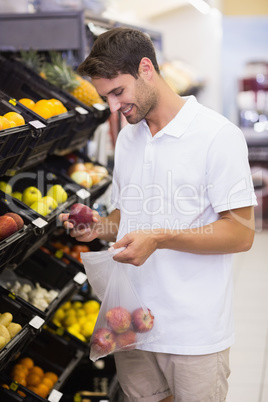 Smiling handsome buying a fruits
