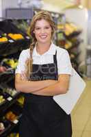 Portrait of a smiling staff woman having a clipboard on her hand