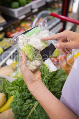 Woman hands pointing at broccolis