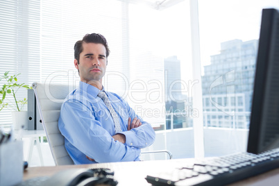 Serious businessman crosses his arms