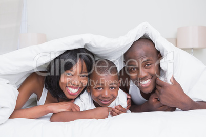 Portrait pretty couple with his son in bed together