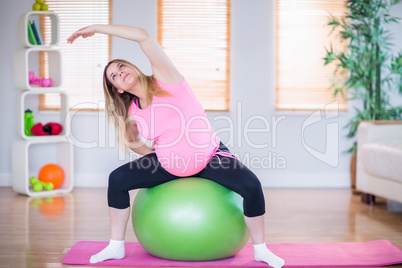 Pregnant woman exercising on exercise ball