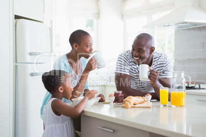 Happy family sitting and taking breakfast