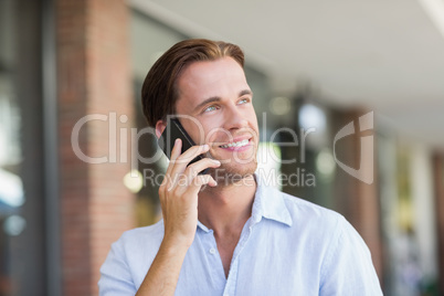 A happy smiling man calling