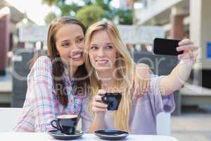 Happy women friends taking a selfie