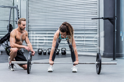 A muscular woman lifting weight