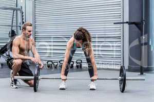 A muscular woman lifting weight