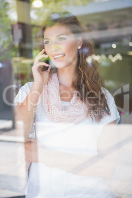 Smiling woman calling with smartphone