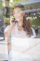 Smiling woman calling with smartphone