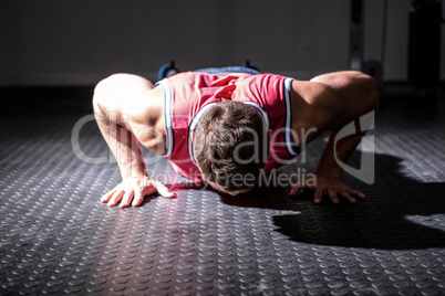 Muscular man doing push-ups