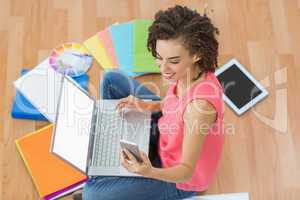 Young creative businesswoman holding a smartphone