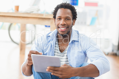 Young creative businessman scrolling on the tablet