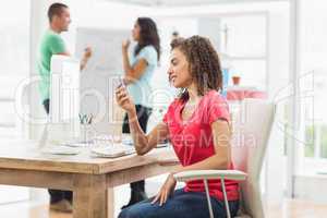 Businesswoman calling someone at her desk