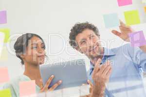 Puzzled business team looking post its on the wall