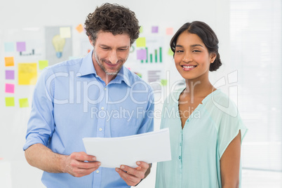 Casual business partners looking at files