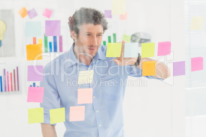Creative businessman looking at post-it