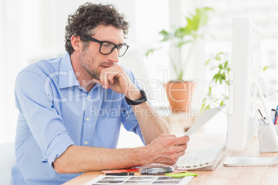 Casual businessman using computer in office