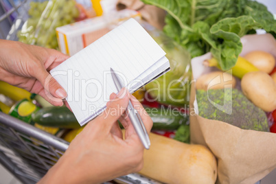 close up view of a notepad above a cart of product