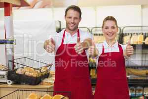 Portrait of smiling bakers with thumb up