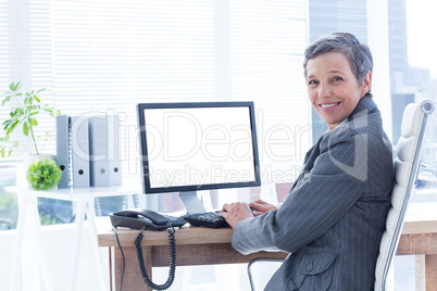 Smiling businesswoman using computer