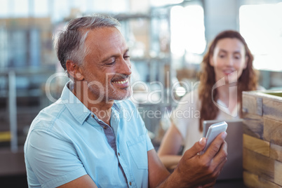 Handsome man using his smartphone