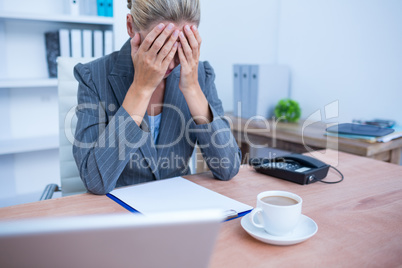 A pretty blonde businesswoman thinking