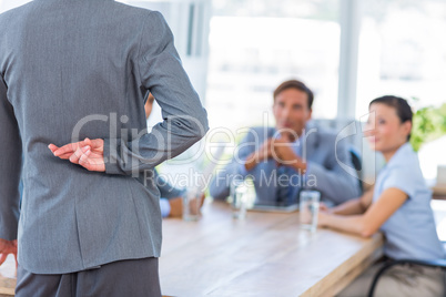 Businesswoman hiding her finger during meeting