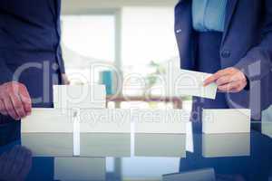 Business people stacking paper bloc
