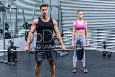 Muscular couple lifting weight together