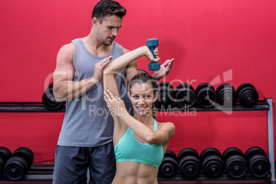 Muscular woman lifting a dumbbell