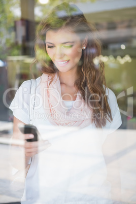 Smiling woman using smartphone