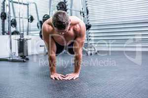 Muscular man doing push-ups