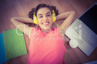 Young creative businesswoman enjoying music