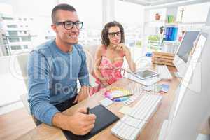 Concentrated coworkers using laptop and digitizer