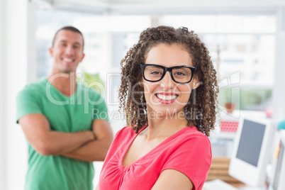 Closeup of a casual female artist with colleague at office