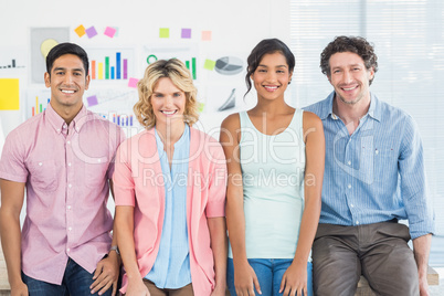 Smiling colleagues standing and posing in a line