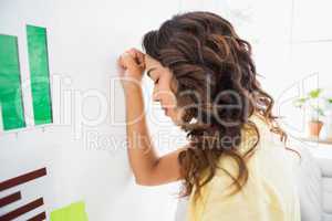 Young businesswoman leaning against the wall