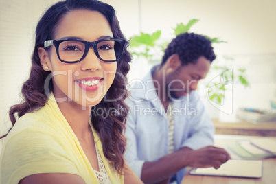 Pretty young businesswoman smiling at the camera