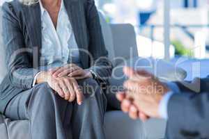 Business people speaking together on couch