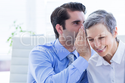 Two business people looking at a paper while working on folder