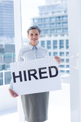 Businesswoman holding a signboard hired