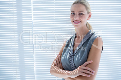 Smiling businesswoman standing in the office